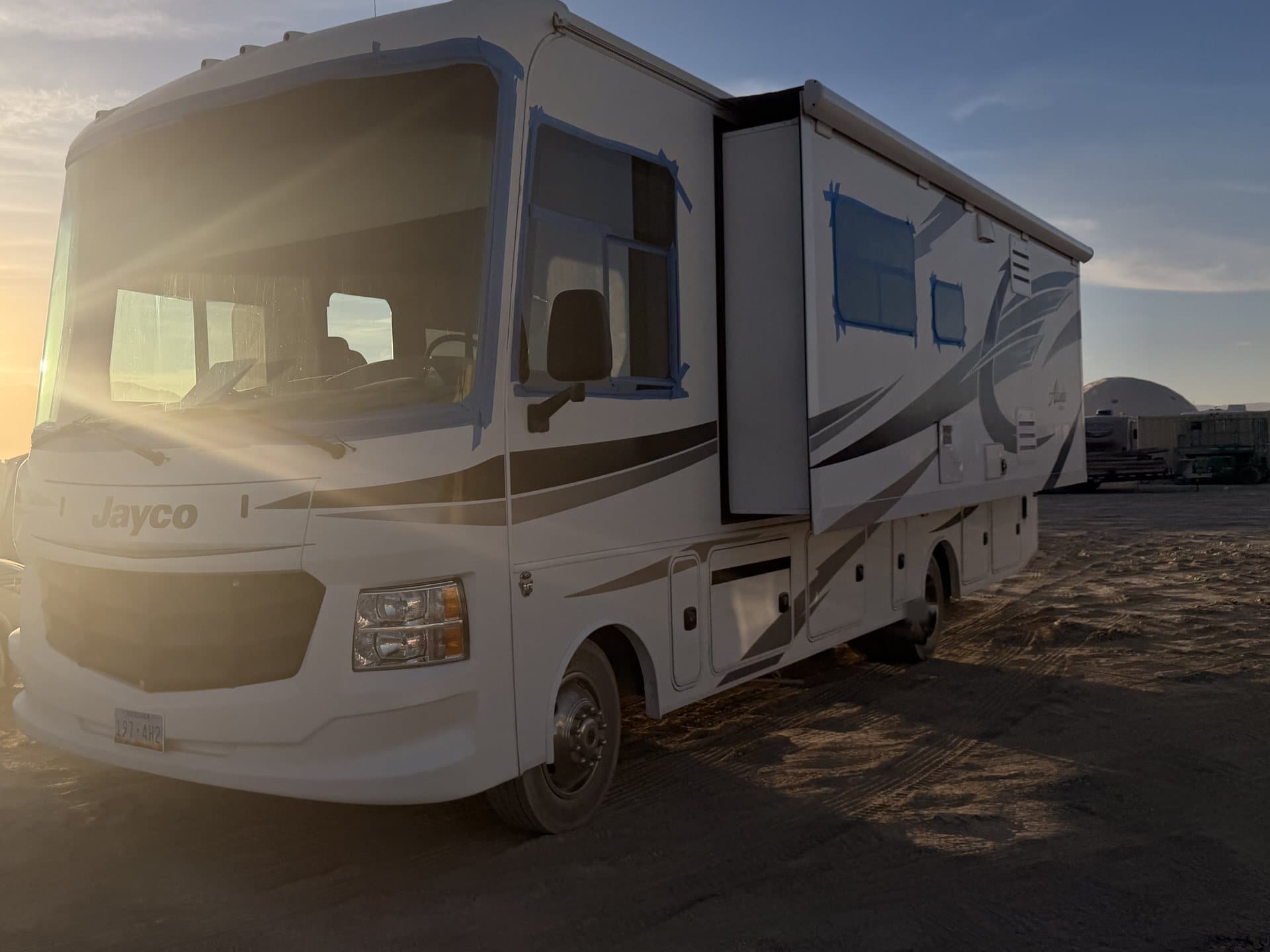 The Alante staged at camp on the playa at sunset, slide out, Black Rock City